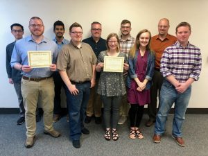 NETC members standing with team award